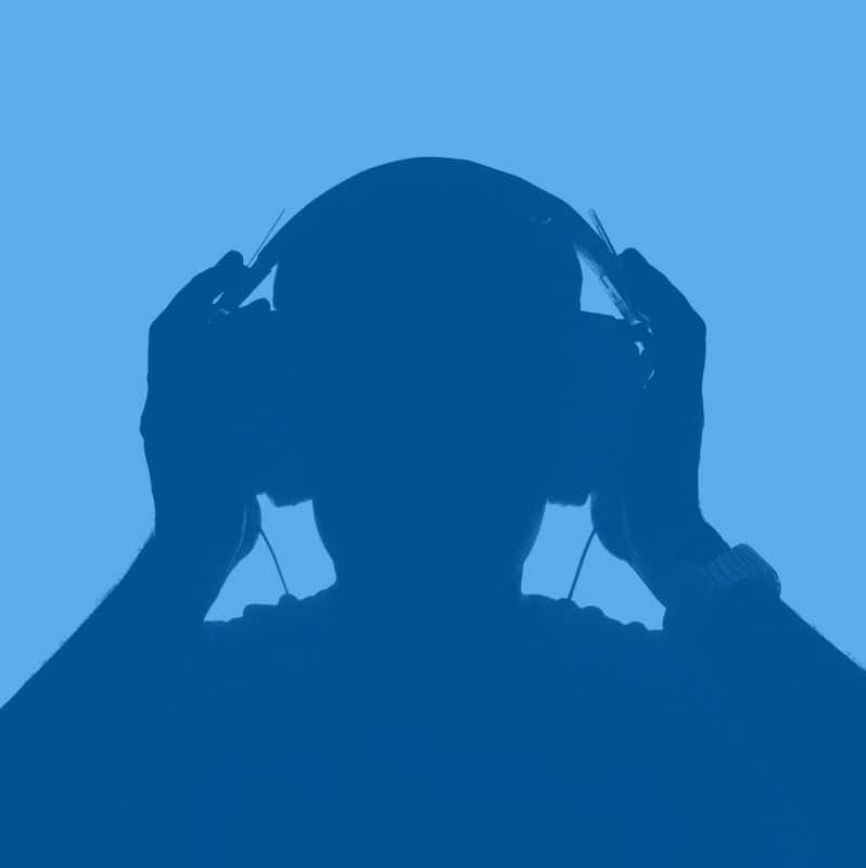 Headphones user enjoying music, silhouette of a person listening to audio.