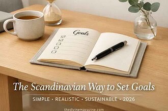 Scandinavian-style desk with goals planner, coffee, and greenery for 2026 goal setting.